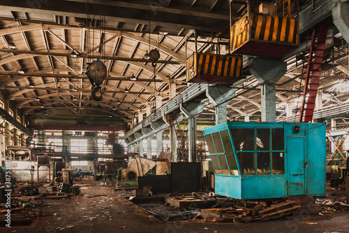 An abandoned old large industrial hall is waiting for demolition, an Industrial crane, A former Khabarovsk plant for the production of a diesel engine.