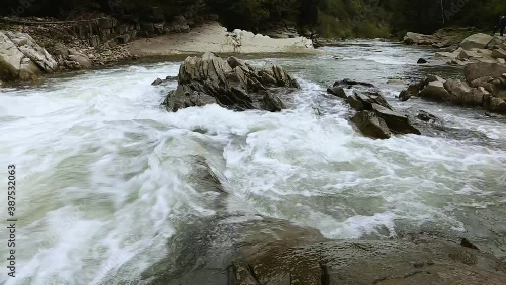 Fast mountain river in the Carpathians. Mountain rapids and gullies. Waterfall on a mountain river. Crystal mountain water. Fast mountain river in the Carpathians. Mountain rapids and gullies. Waterfall on a mountain river. Crystal mountain water.