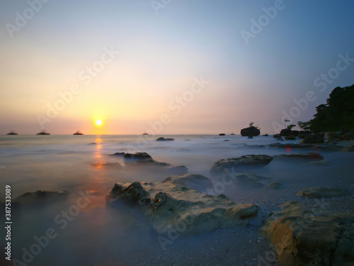  sea ​​background, sunset with the fog crashing waves hitting the coral reefs