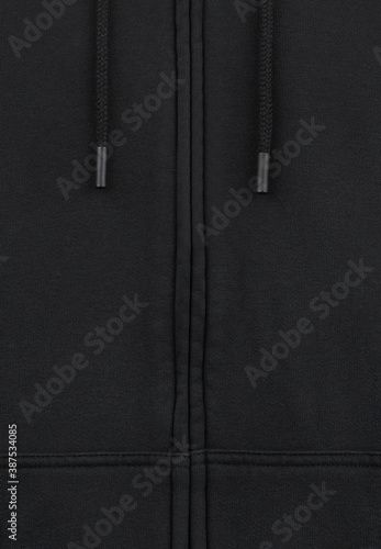 Part of black sweatshirt with zipper and with laces close up