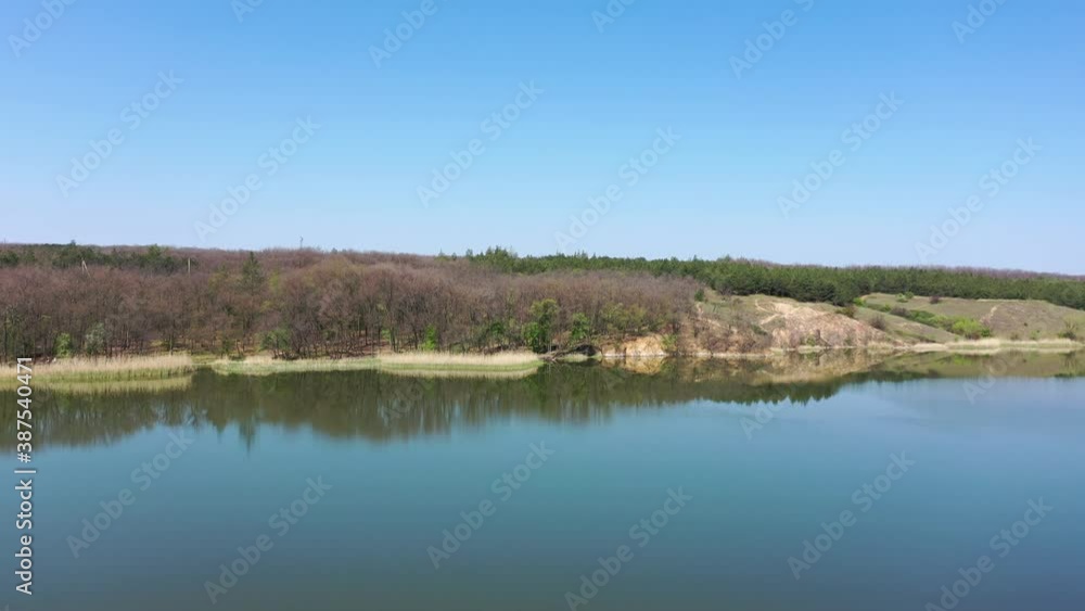 Pond near the forest in spring. Aerial view Pond near the forest in spring. Aerial view