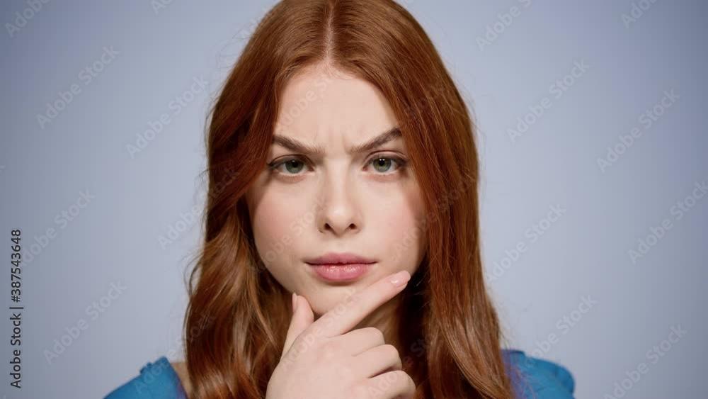 Doubt woman getting an idea in studio. Closeup curious girl thinking indoors Doubt woman getting an idea in studio. Closeup curious girl thinking indoors