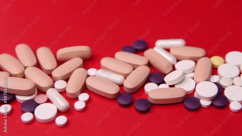 Various pills macro on red background. Top view Various pills macro on red background. Top view