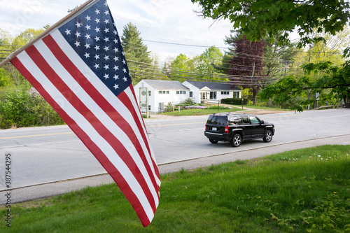 American flag and a black SUV