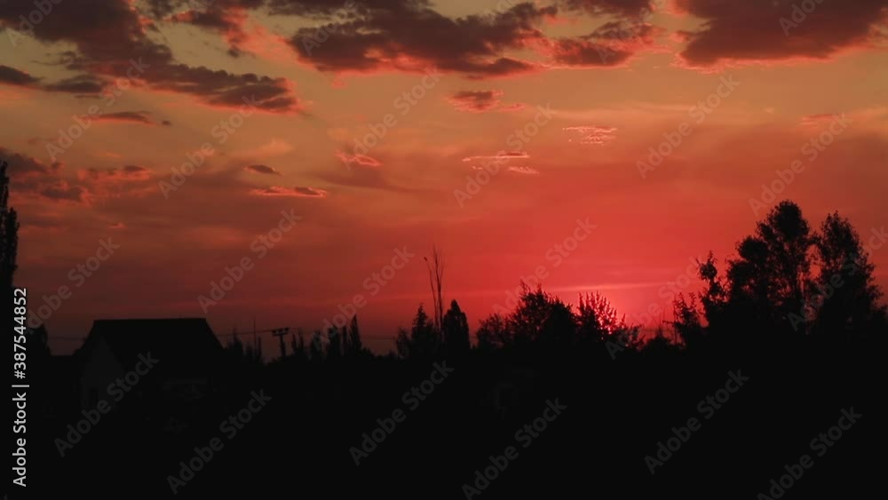 Beautiful sunset on the background of houses and trees. Beautiful sunset on the background of houses and trees.