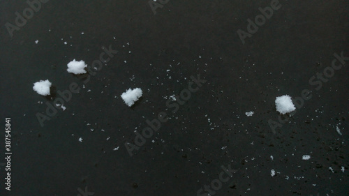 Clumps of snow on the dark ice