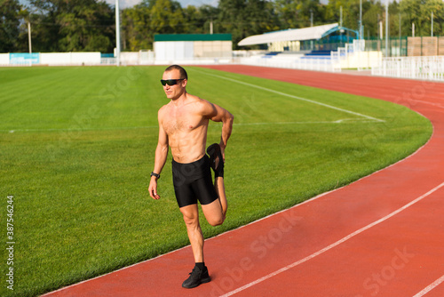 Runner stretches his legs on the track