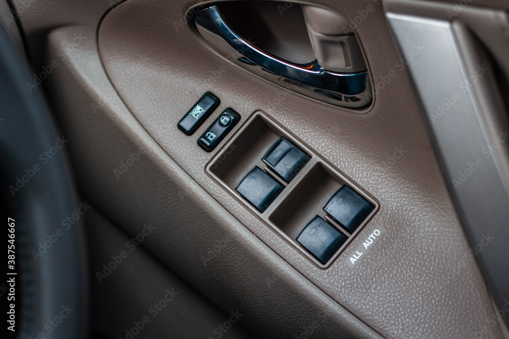 Car arm rest with Control Panel. Door Lock & Mirror Control. window adjustment buttons, door lock. Photography of a modern car.