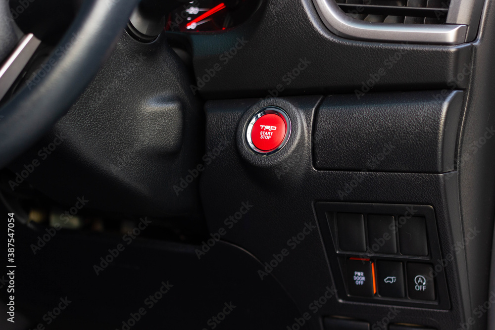 Close up engine car start button. Start stop engine modern new car button,Makes it easy to turn your auto mobile on and off. a key fob unique ,selective focus Close up engine car start button. Start stop engine modern new car button,Makes it easy to turn your auto mobile on and off. a key fob unique ,selective focus