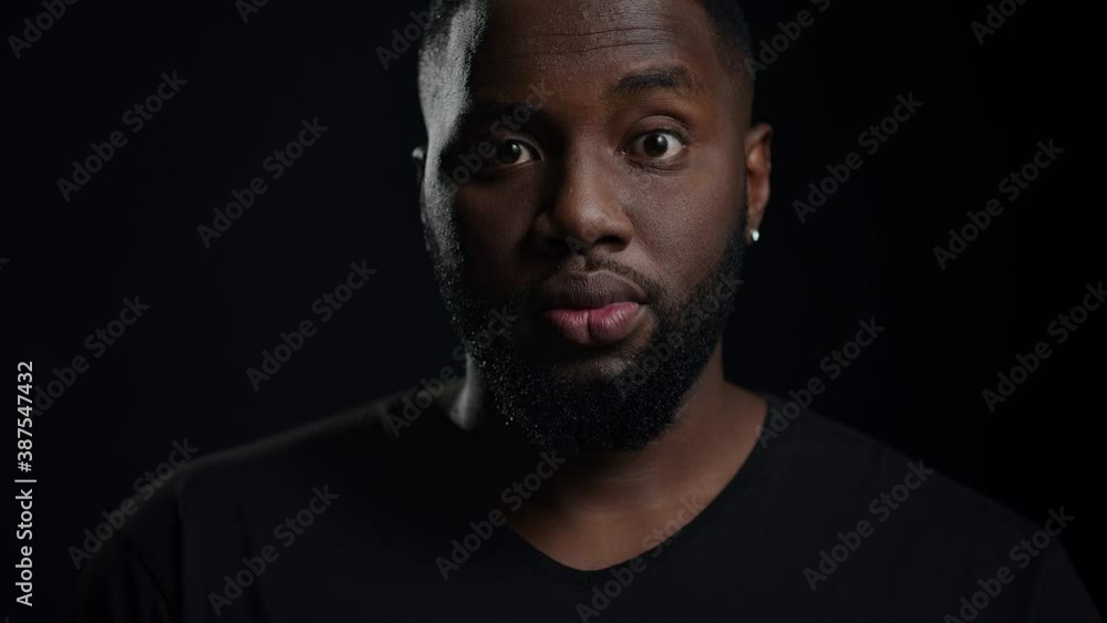 Euphoric afro guy looking at camera indoors. Male person saying wow in studio Euphoric afro guy looking at camera indoors. Male person saying wow in studio