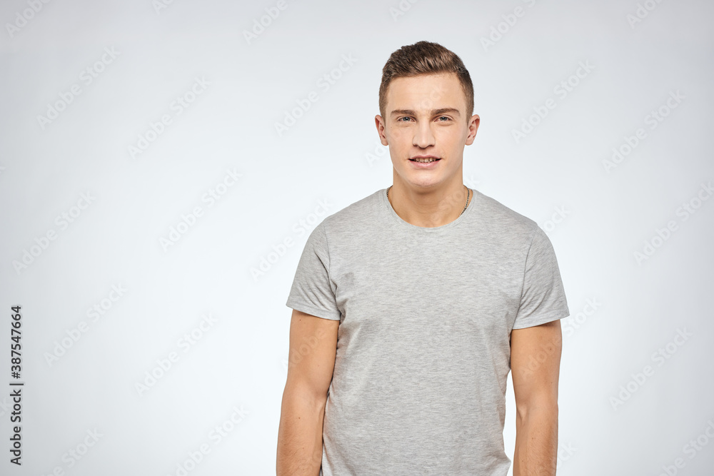 man in gray t-shirt emotions light background cropped view man in gray t-shirt emotions light background cropped view