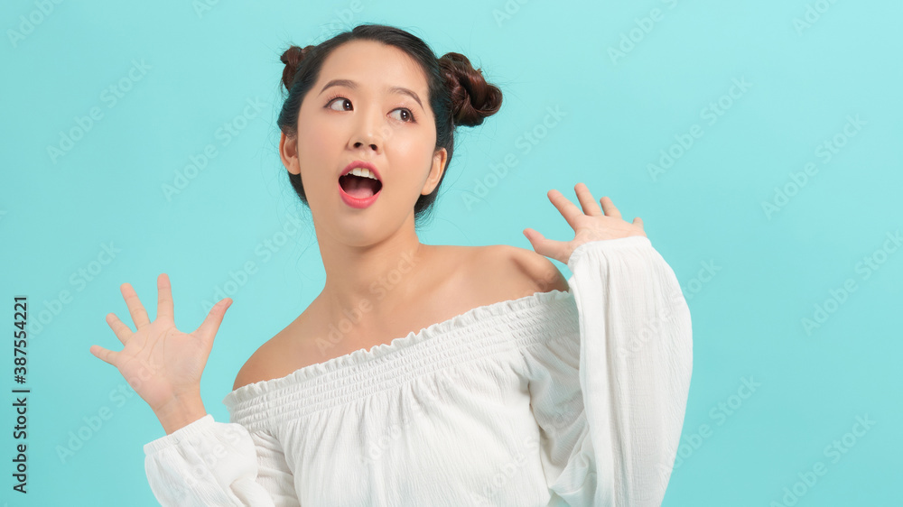Image of surprised woman in white clothes over blue background. Image of surprised woman in white clothes over blue background.