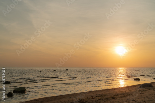 Sunset on baltic sea beach with rocks in sand © GCapture