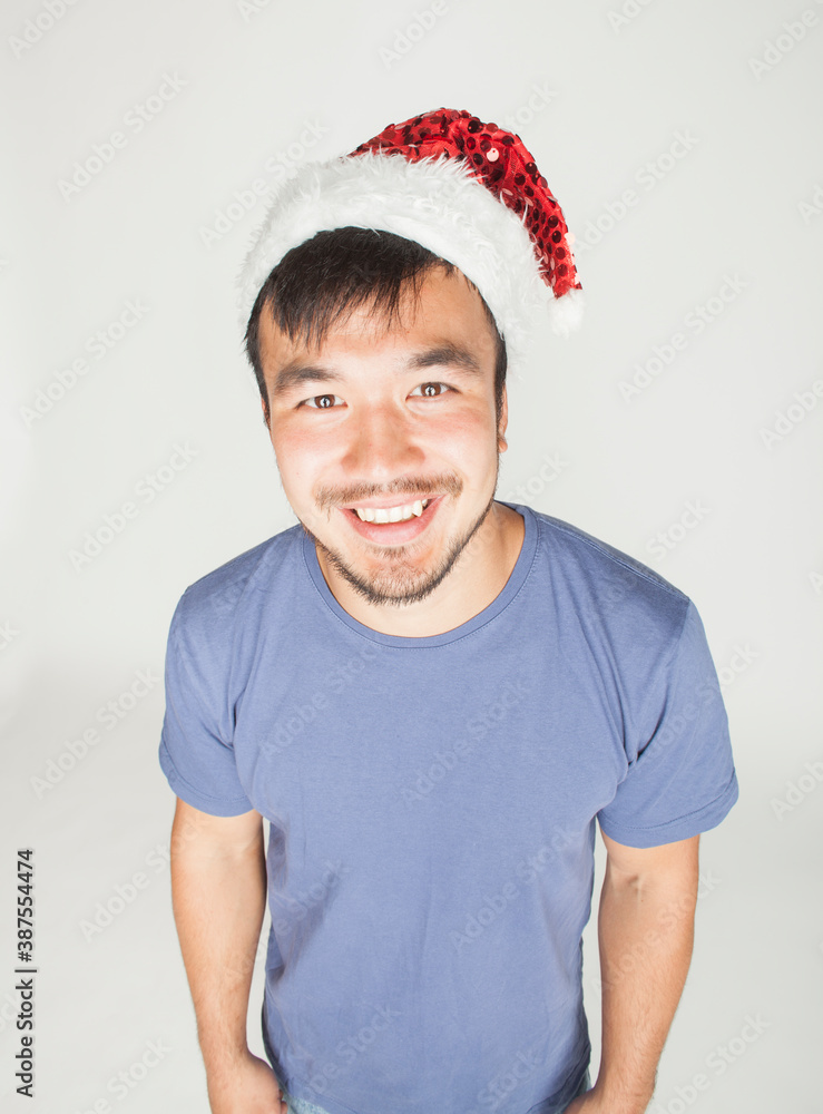 funy exotical asian Santa claus in new years red hat smiling funy exotical asian Santa claus in new years red hat smiling
