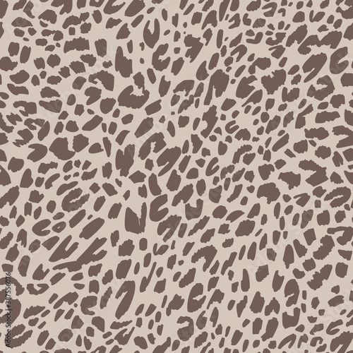 Seamless pattern made of leopard spots skin texture. African animal fur background. Spotted ornament. Vintage style. Good for wrapping, banner, fashion, textile and fabric.