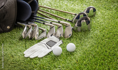Schilderij op canvas Golf equipment on green grass golf course, close up view.