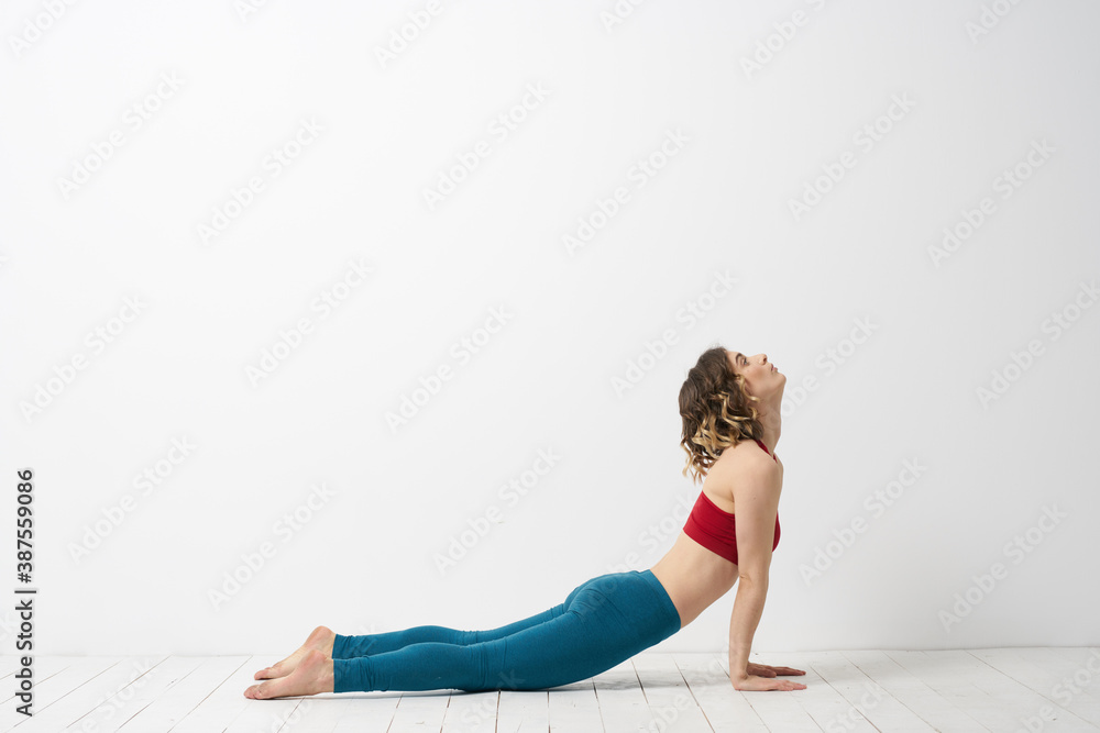 woman in leggings is engaged in gymnastics in a light room slim figure fitness sport woman in leggings is engaged in gymnastics in a light room slim figure fitness sport