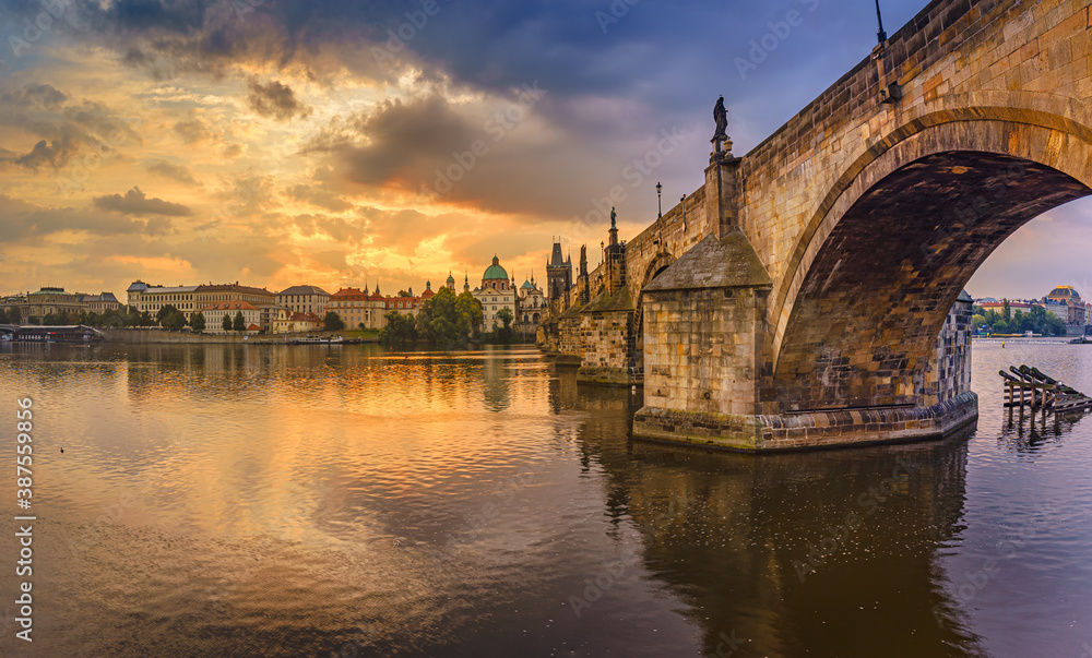 Charles bridge over the Vltava river in Prague at sunrise