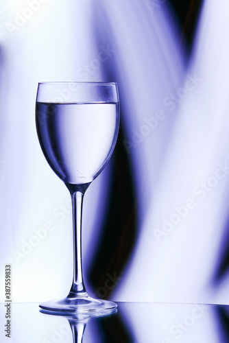 beautiful wine glass with a drink on the table