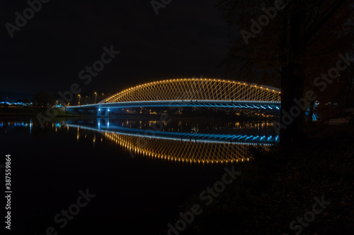 lighting traffic bridge over the Vltava river in the center of Prague at night in the Czech Republic on October 22