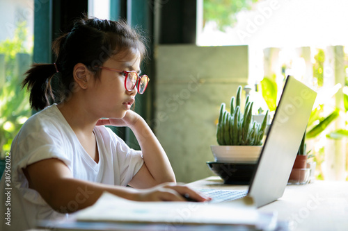 asian children working on computer laptop at home