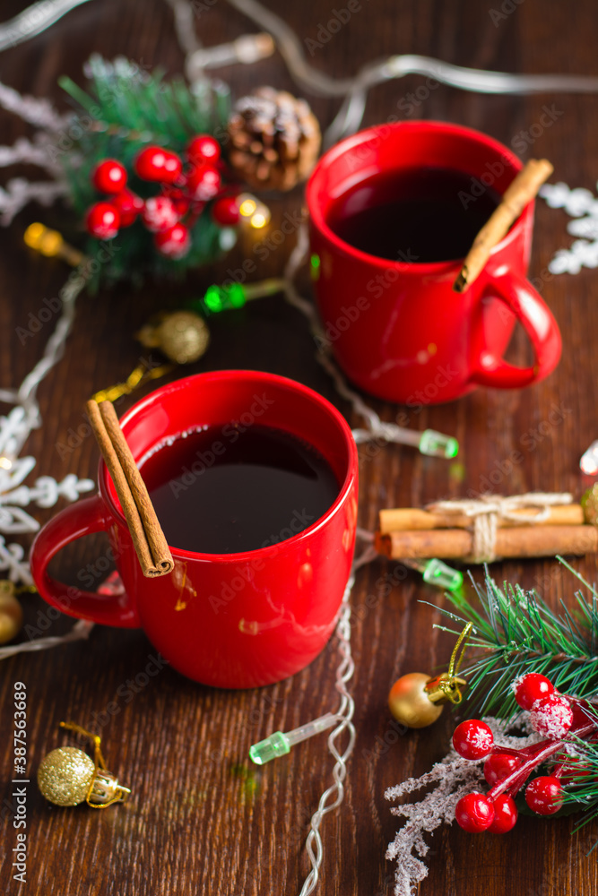 Delicious mulled wine with cinnamon in red cups. Concept waiting for christmas, top view, vertical format Delicious mulled wine with cinnamon in red cups. Concept waiting for christmas, top view, vertical format