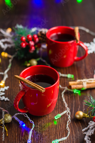 Delicious mulled wine with cinnamon in red cups. Concept waiting for christmas  top view  vertical format