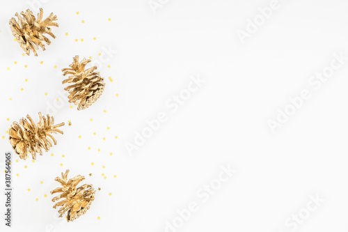 Christmas holiday composition. Golden cones. Xmas golden decorations on white background. Christmas, New Year, winter concept. Flat lay, top view, copy space