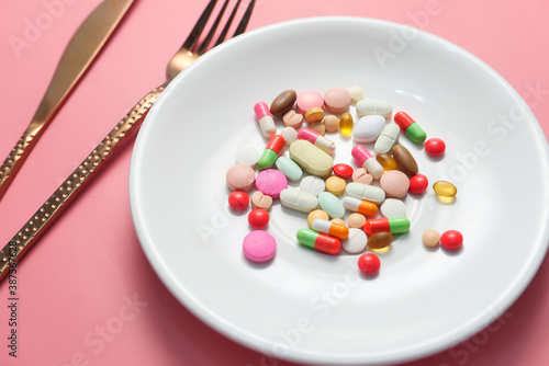 close up of colorful pills on plate 