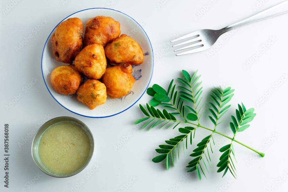 Fresh mysore bonda in a plate on a white background Fresh mysore bonda in a plate on a white background