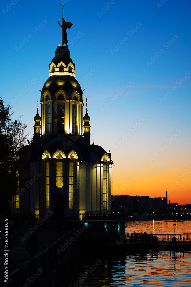 Christian temple by the water at sunset
