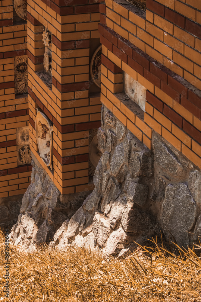 Beautiful building on a stone foundation. Brickwork with niches. Beautiful building on a stone foundation. Brickwork with niches.