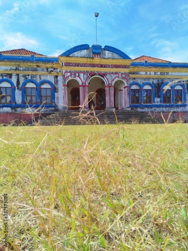 A beautiful school building on background with grass as foreground. photo