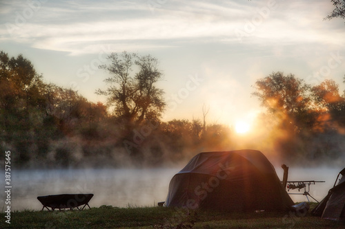 Sunny and foggy morning by the lake during fishing time
