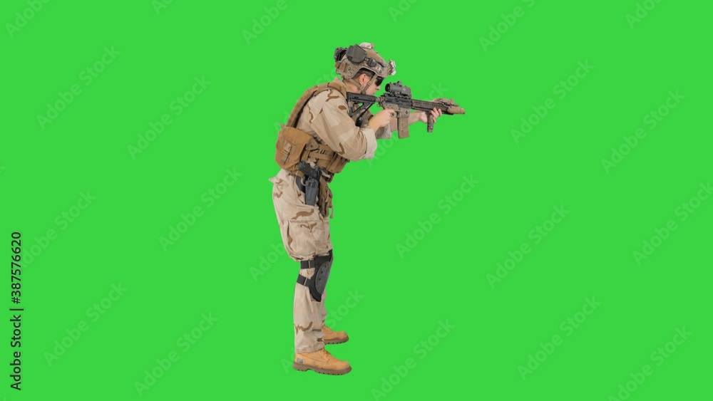 Soldier aiming and shooting automatic rifle on a Green Screen, Chroma Key. Soldier aiming and shooting automatic rifle on a Green Screen, Chroma Key.