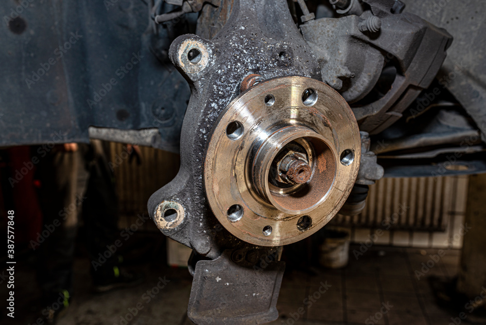 New front hub mounted in a car on a steering knuckle without a brake disc.