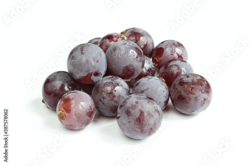 Group of dark wet grapes isolated on white background