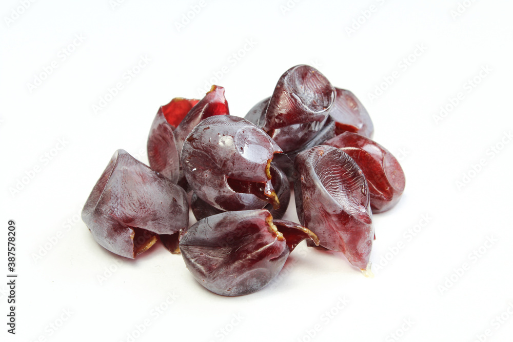 Pile of dark grapes skin isolated on white background. Grape peel macro