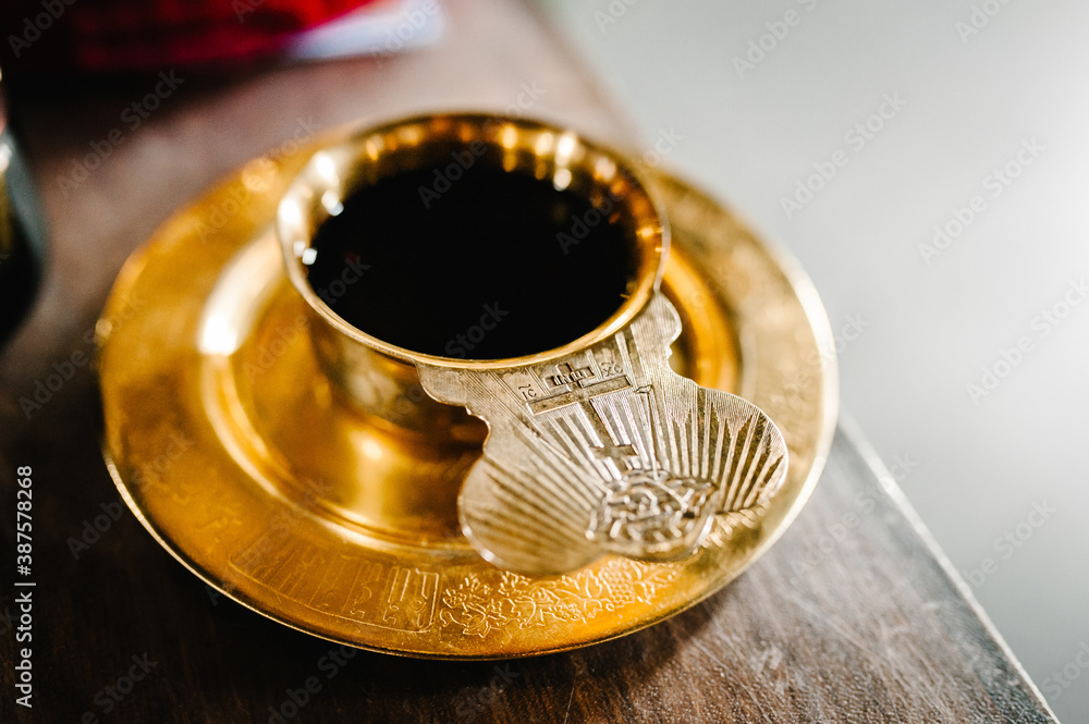 Holy communion on wooden table on church. Taking Communion. Cup of glass with red wine.