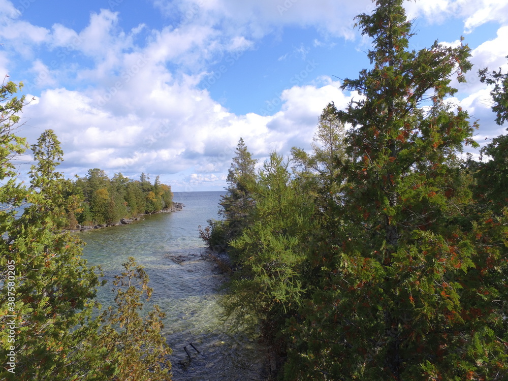 View of Georgian Bay Lake Waters framed by Juniper and Cedar Trees on Shoreline View of Georgian Bay Lake Waters framed by Juniper and Cedar Trees on Shoreline