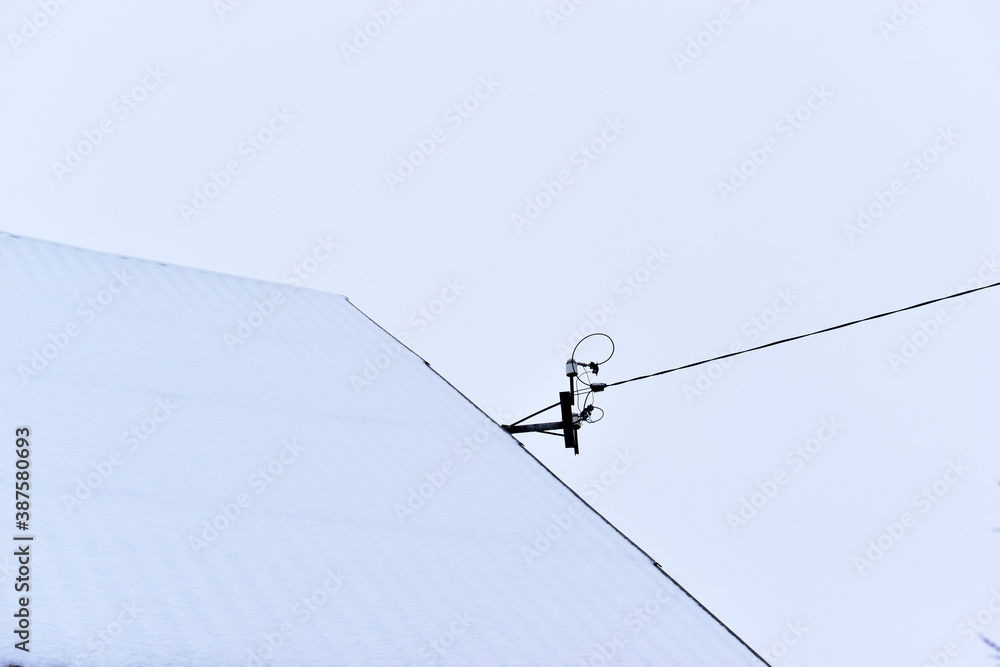 Snow roof and power line wires in winter Snow roof and power line wires in winter