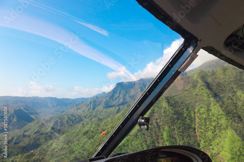 The cockpit from the inside when flying on the island of Kaui Hawaiian islands. Green Mountains aerial view photo