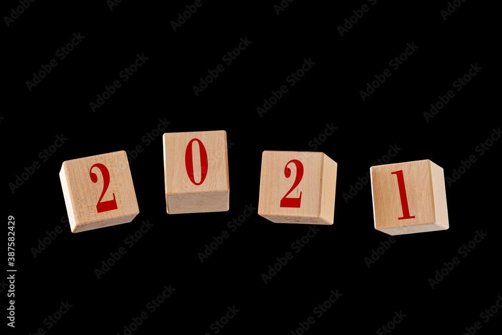 Four cubes floating in the air with the numbers 2021 isolated on a black background. Four cubes floating in the air with the numbers 2021 isolated on a black background.
