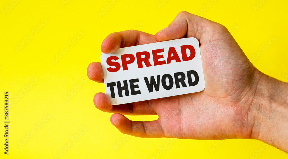 businessman holding a card with text SPREAD THE WORD businessman holding a card with text SPREAD THE WORD