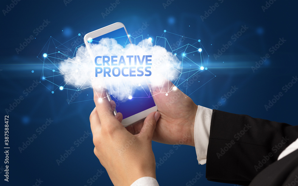 Female hand touching smartphone with CREATIVE PROCESS inscription, cloud business concept Female hand touching smartphone with CREATIVE PROCESS inscription, cloud business concept