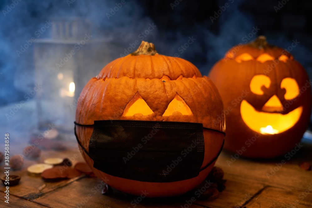 Scary spooky Halloween pumpkin head jack o lantern in covid-19 virus mask.  - obrazy, fototapety, plakaty 