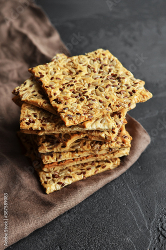 Obraz na plátně Multigrain crunchy crispbread on a dark concrete background.