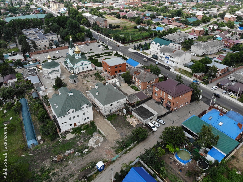Fototapeta premium Christian temple in the center of the village from above