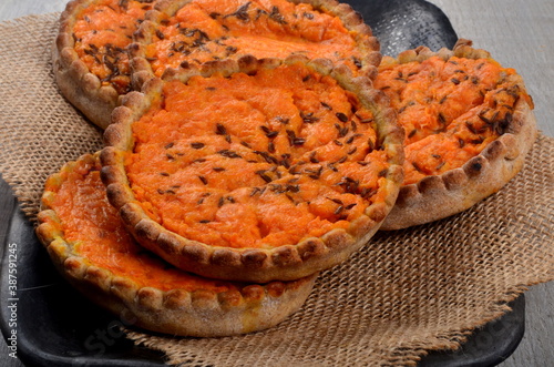 Traditional Latvian carrot at the sklandrausis. Latvian dessert at Sklandrausis with carrot and rye dough photo