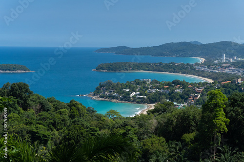 The seascape of the cove islet Phuket island Thailand famous tourist destination in the mid summer holiday with the deep blue ocean and clear sky with the mountain full of forest tree as background